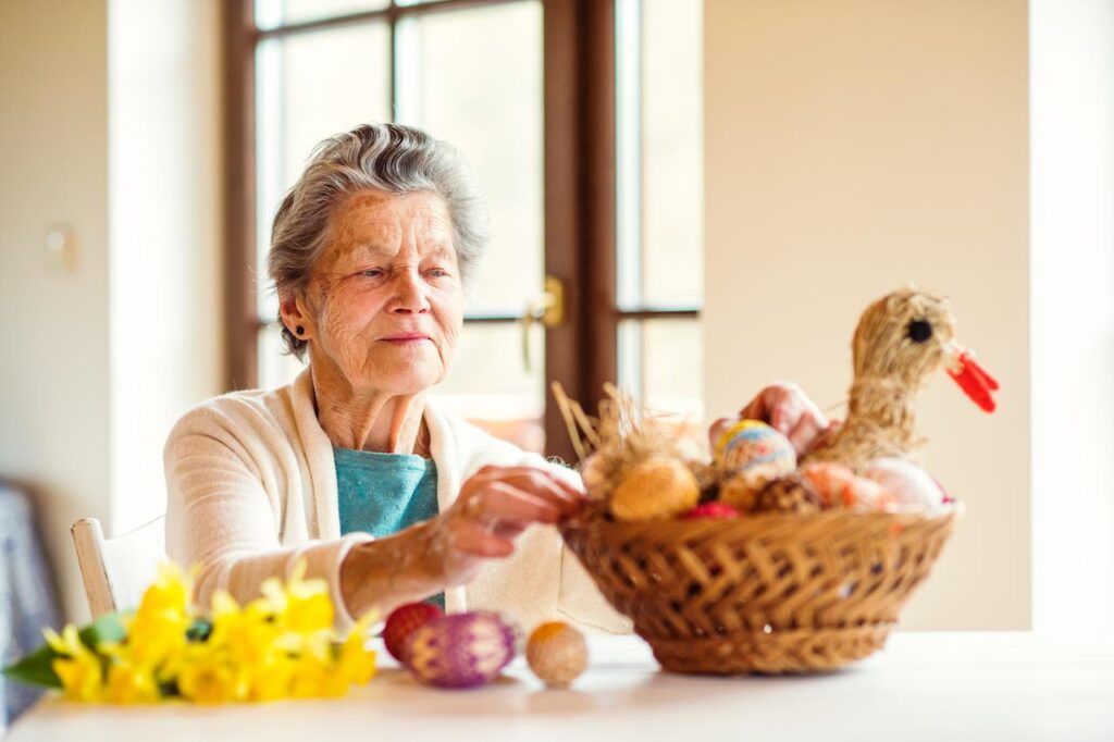 Woman Arranging Basket with Easter Eggs 