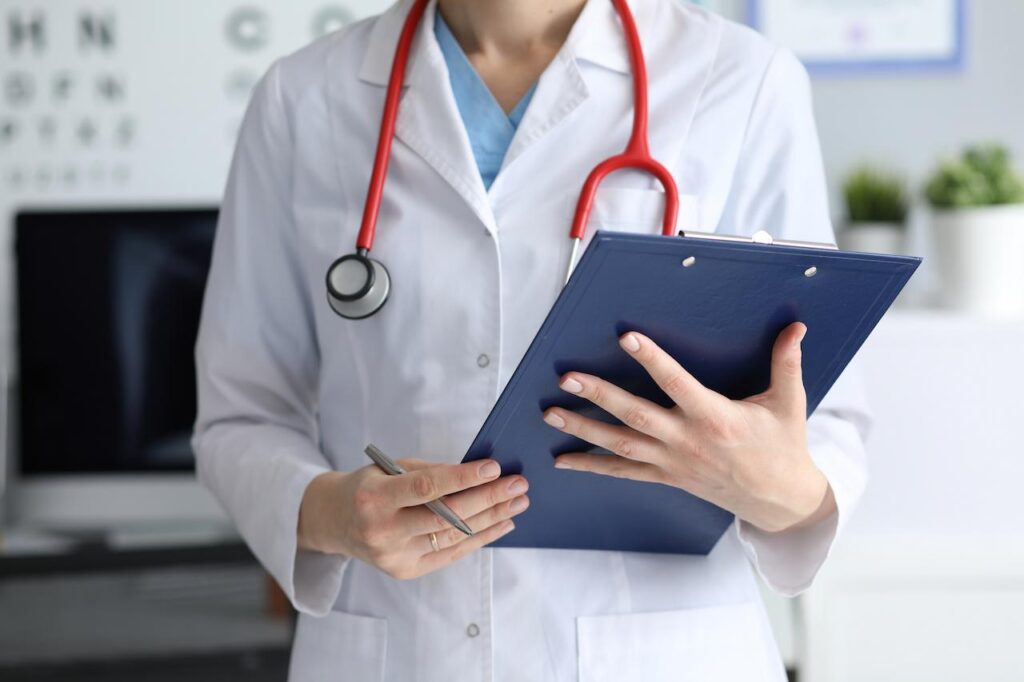 Woman Doctor Holding Clipboard With Documents